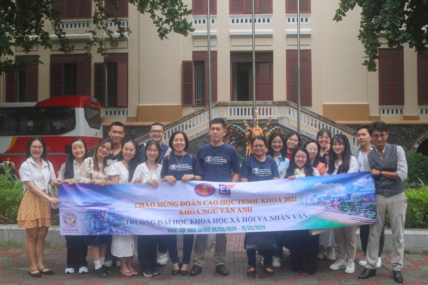 A group of people holding a banner

Description automatically generated